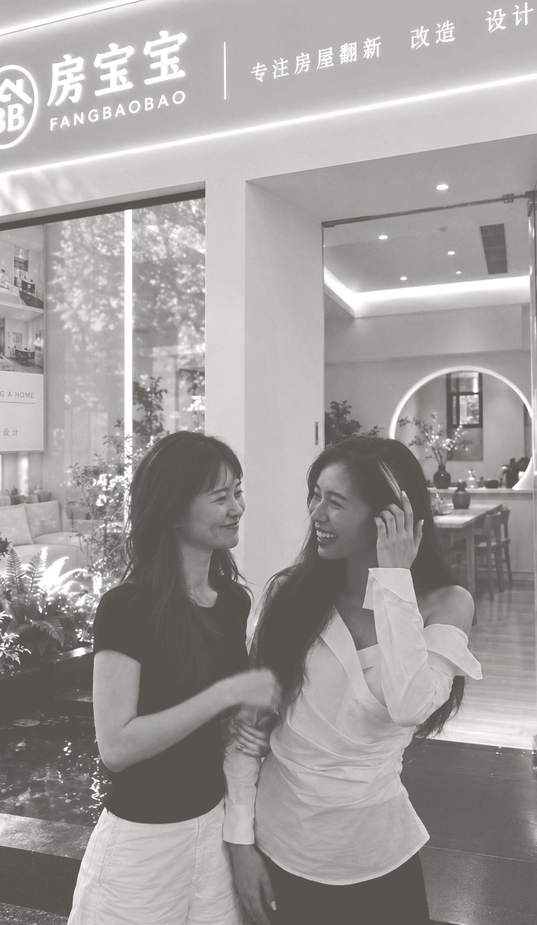 The two FangBaoBao founders laughing together outside their Shenzhen studio